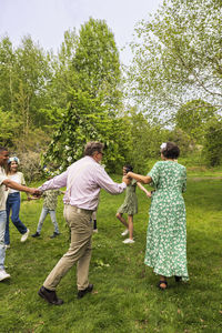 People dancing around midsummer maypole