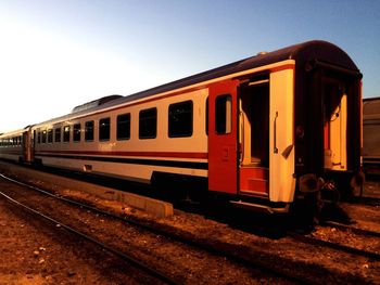 Train at railroad station against clear sky