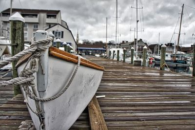 Boat moored on wooden pier