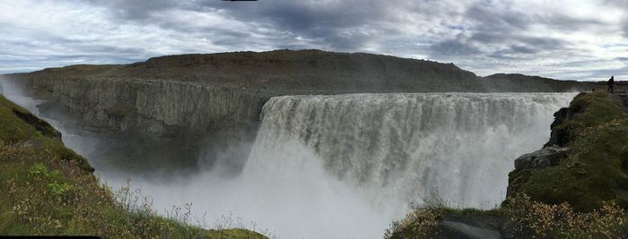 Panoramic view of waterfall against sky