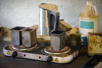 Close-up of objects on table against wall