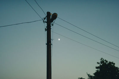 Low angle view of electricity pylon against sky