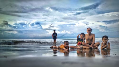 Swimming in sea against sky