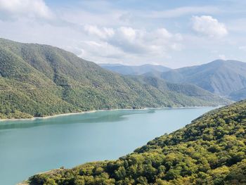 Scenic view of lake and mountains against sky