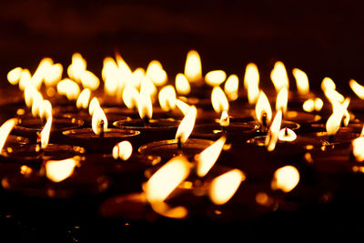 Close-up of lit candles in temple