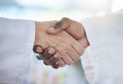 Midsection of couple holding hands