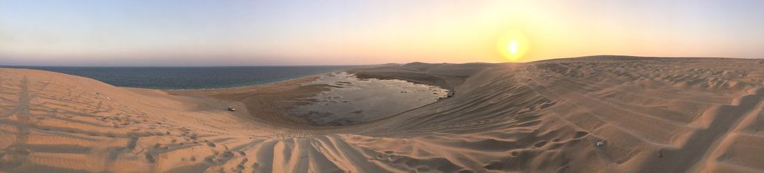 Scenic view of desert against sky during sunset