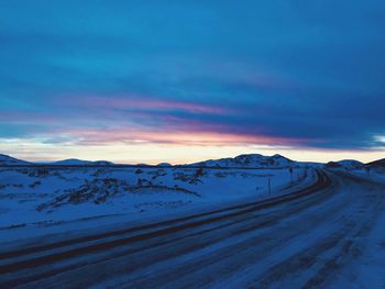 Scenic view of snowcapped mountains against sky during sunset