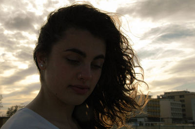 Close-up of beautiful woman against sky