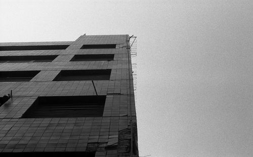 Low angle view of skyscraper against clear sky