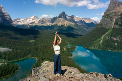 Rear view of woman standing on mountain