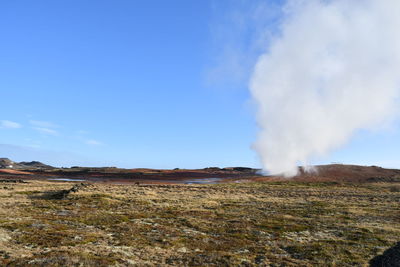 Scenic view of landscape against blue sky