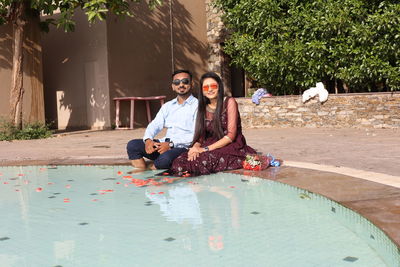 Portrait of smiling young couple sitting outdoors