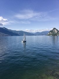 Sailboat sailing on sea against sky