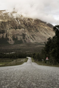 Road amidst landscape against sky