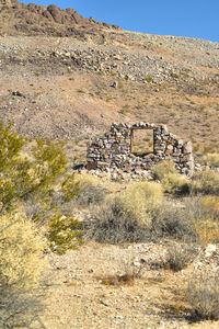 View of abandoned building with mountain in background