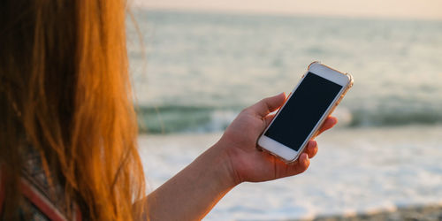 Midsection of man using mobile phone