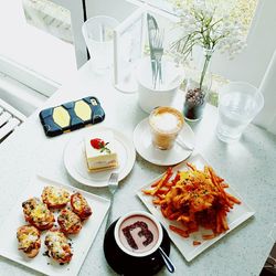 High angle view of fresh breakfast served with coffee on table