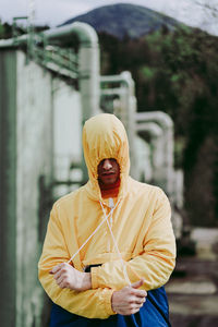 Man wearing hooded shirt while standing outdoors