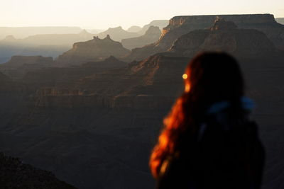 Rear view of woman standing on mountain