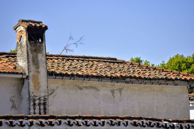 Low angle view of roof and building against sky