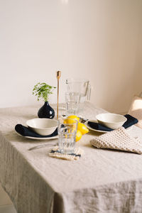 Vintage table setting with linen napkins and yellow lemons.