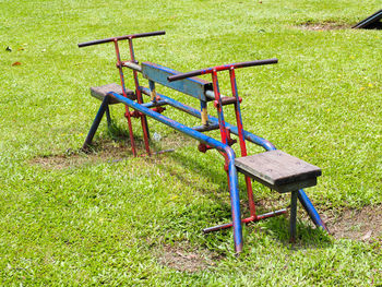 Empty chair on field in park