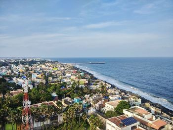 High angle view of townscape by sea against sky