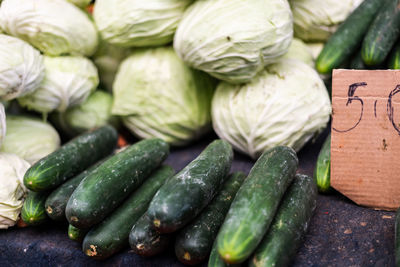 Cabbages and cucumbers stacked and ready for sale. organic concept.