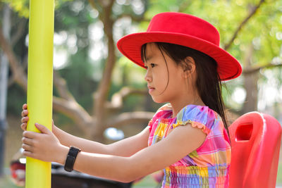 Close-up beautiful little girl wear red hat. summer concept..