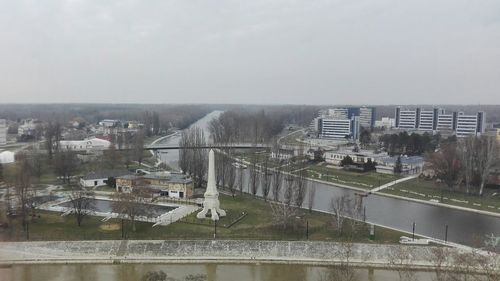 Aerial view of factory against sky in city