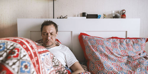 Midsection of man sitting at home
