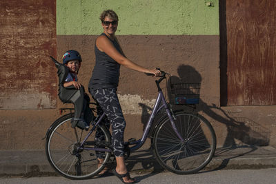 Full length of mother and her son on bicycle