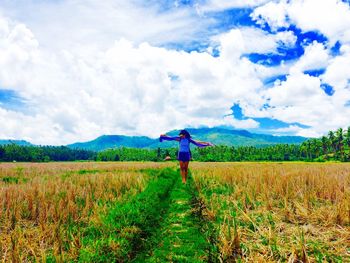 Rear view of man standing in field