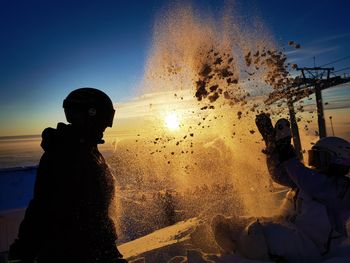 Shadow of lovers playing with snow