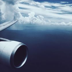 Airplane flying over sea against sky