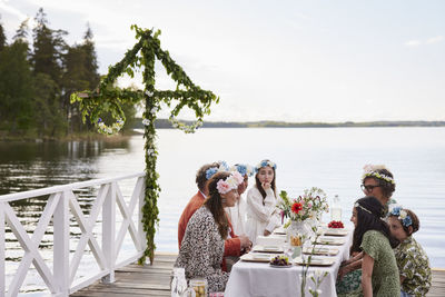 Family having midsummer dinner by lake