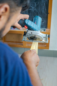 Hand held worm drive circular saw cutting boards at home. diy renovation makeover project.