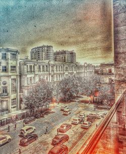 High angle view of city street by buildings against sky