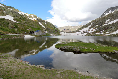 Scenic view of lake and mountains against sky