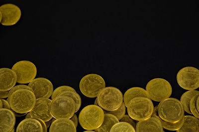 Close-up of coins on black background