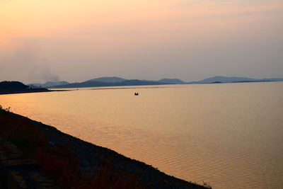 Scenic view of beach against sky during sunset