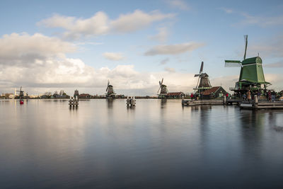 Sailboats in sea against sky