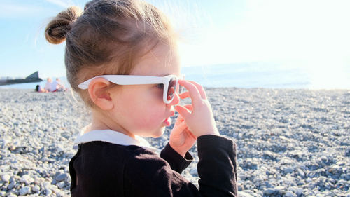 Portrait of woman wearing sunglasses at beach