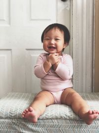 Cute baby girl sitting at home