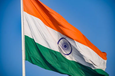 India flag flying high at connaught place with pride in blue sky, india flag fluttering, indian flag