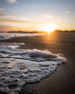 Sea waves rushing towards shore during sunset