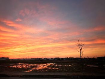 Silhouette landscape against dramatic sky during sunset