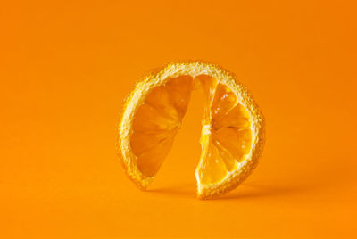 Close-up of orange over white background