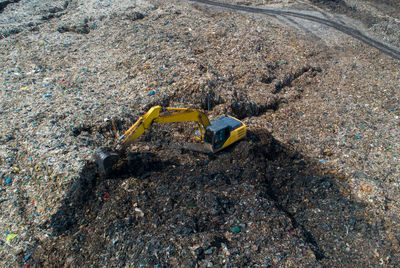 High angle view of yellow lines on rock at construction site